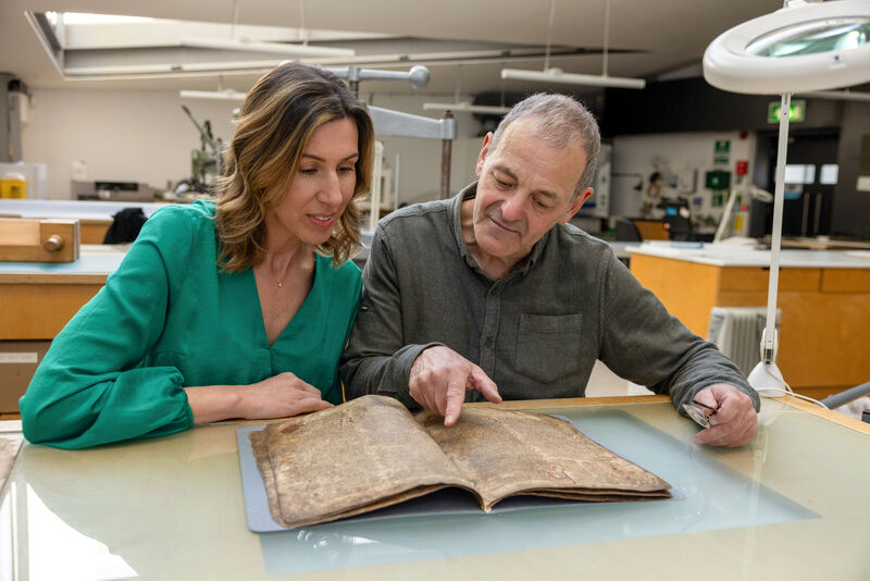Chief manuscript conservator Dr John Gillis and curator Caoimhe Ní Ghormáin, both from the Library of Trinity College Dublin, view newly-conserved pages from the Book of Leinster last year. Picture: Paul Sharp/Sharpix