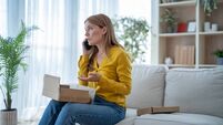 Woman complaining on phone about damaged package at home