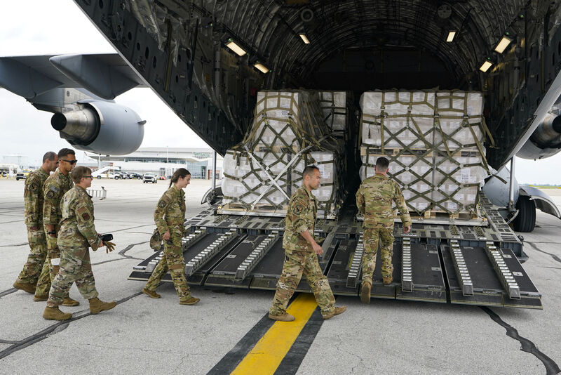 Crew members of a C-17 begins to unload a plane load of baby formula at the Indianapolis International Airport in Indianapolis, Sunday, May 22, 2022. The 132 pallets of Nestlé Health Science Alfamino Infant and Alfamino Junior formula arrived from Ramstein Air Base in Germany (AP Photo/Michael Conroy)