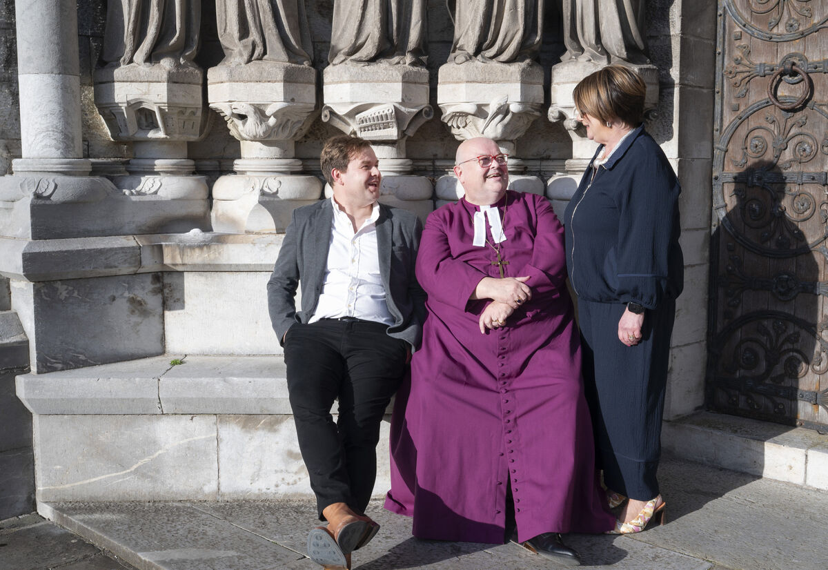 Bishop Paul Colton with Adam, one of his two sons, and his wife Susan after the farewell service at St Fin Barre’s Cathedral in Cork. Picture: Gerard McCarthy