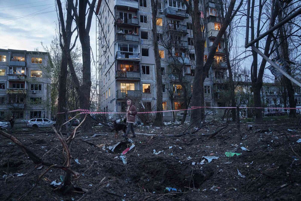 A woman walks among the rubble of a house damaged after a Russian strike in Kyiv in April. It is an aim of the Russian Federation — to terrorise the civilians of Ukraine and to force migration into Europe to sow discord and destabilize the European Union. Photo: AP/Evgeniy Maloletka
