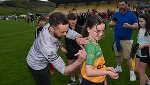 <p>Down manager Conor Laverty signs a jersey for a Donegal supporter. Pic: Ramsey Cardy/Sportsfile</p>