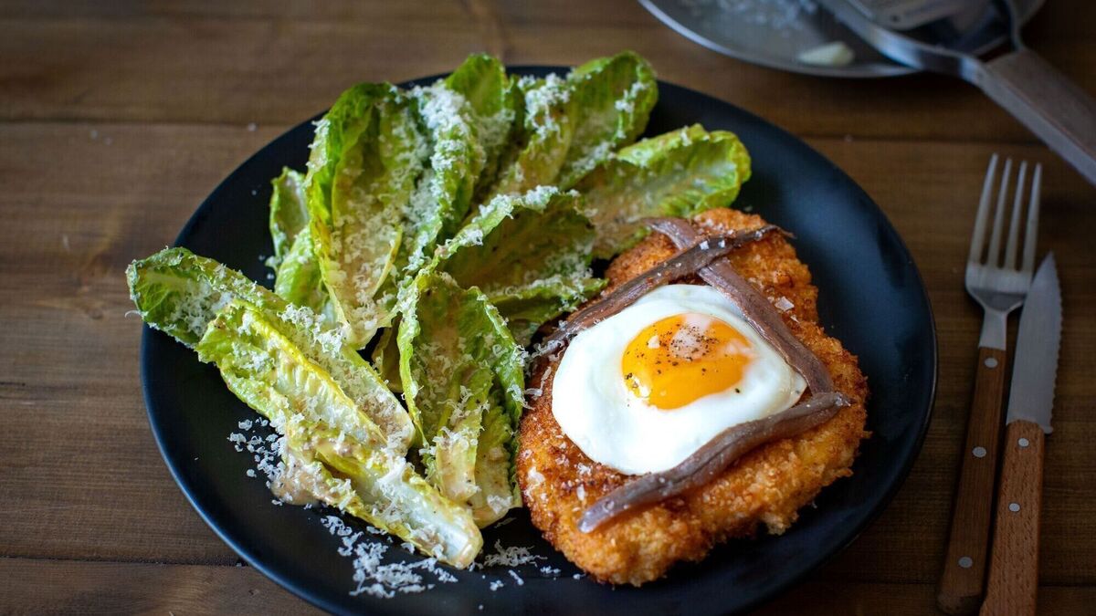 Chicken Schnitzel with fried egg and Caesar salad
