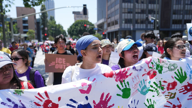 Demonstrators march during a May Day rally in Los Angeles (Jae C Hong/AP)