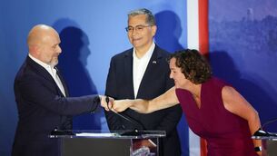<p>Former US Secretary of Health and Human Services Xavier Becerra (C) looks on as Former Democratic US Representative Katie Porter and Republican political commentator Steve Hilton fist bump during a California gubernatorial debate at Bridges Auditorium on the campus of Pomona College in Claremont, California, on April 28, 2026. The eight candidates for California governor are participating in the second televised debate, ahead of the June 2, 2026 primary elections. (Photo by Patrick T. Fallon / AFP via Getty Images)</p>