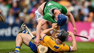 <p>ROUGH AND TUMBLE: Shane O'Brien of Limerick tussles with David McInerney of Clare. Pic: Tom Beary/Sportsfile</p>