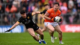 <p>Paddy Burns of Armagh is tackled by Daniel Guinness of Down during the Ulster SFC semi at St Tiernach's Park in Clones, Monaghan. Photo by Ben McShane/Sportsfile</p>