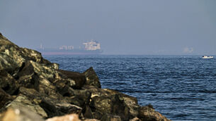 Cargo ships are seen at sea in the Gulf of Oman near the Strait of Hormuz (Fatima Shbair/AP)
