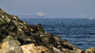 <p>Cargo ships are seen at sea in the Gulf of Oman near the Strait of Hormuz (Fatima Shbair/AP)</p>