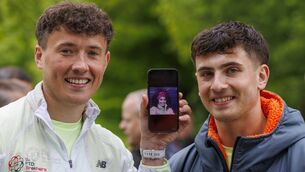 <p>Jordan Adams (left) holds an image of his mother Geraldine as he stands with his brother Cian ahead of the start of day eight of a 32-day fundraising run in Ireland. Photo: Liam McBurney/PA</p>