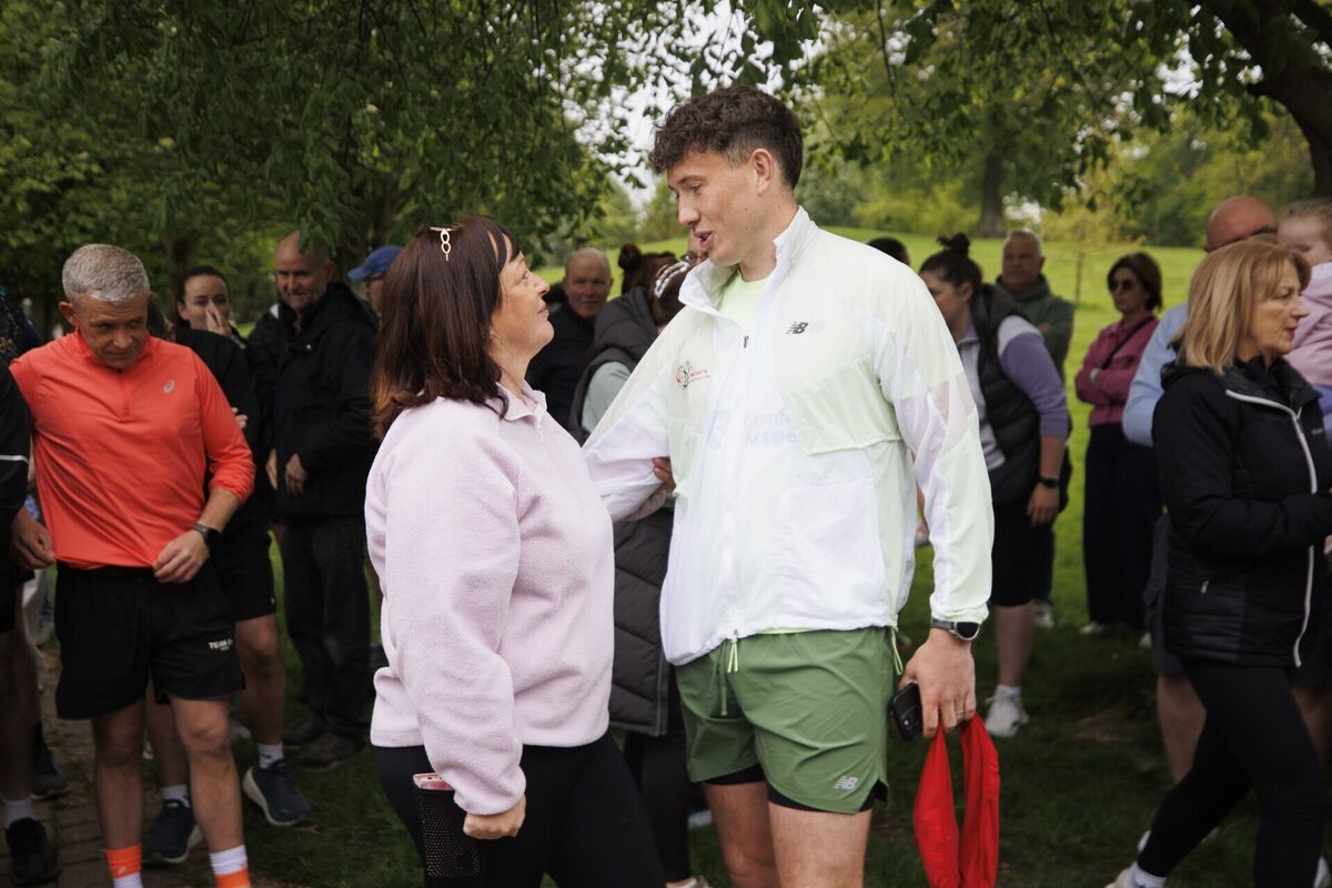 Jordan Adams (centre) at Ice House Hill Park in Dundalk speaks with Jennifer Black who has had her own family experience with dementia. Photo: Liam McBurney/PA