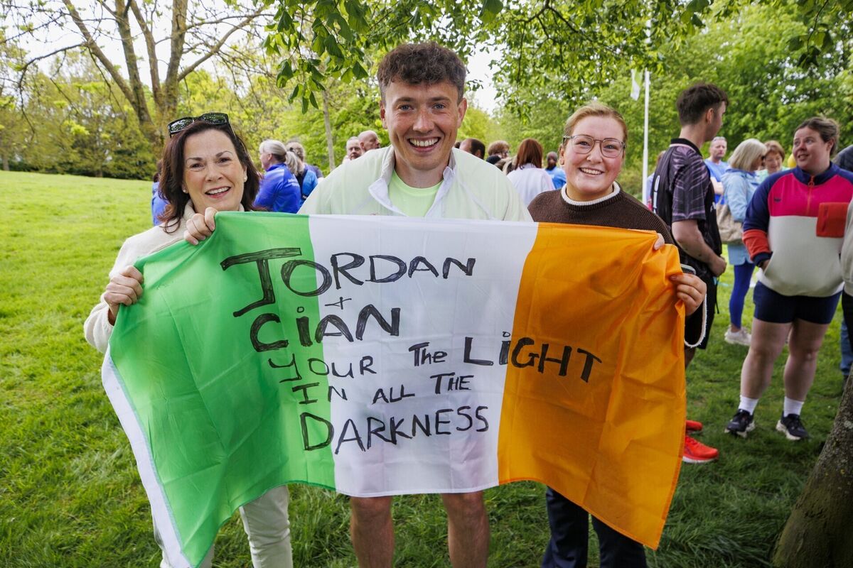 Jordan Adams (centre) with Gwen Cotter (left) and her daughter Katie Cotter, who came out to show their support for his 32-day fundraising run in Ireland. Photo: Liam McBurney/PA