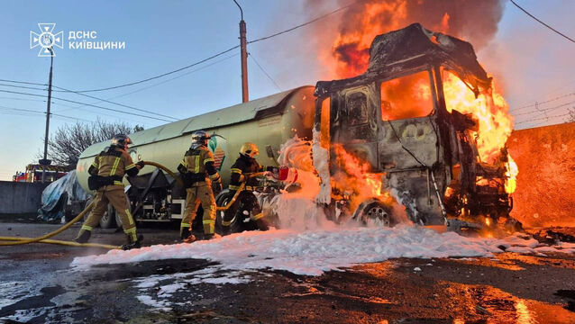 <p>Emergency services personnel work to extinguish a vehicle fire following a Russian drone attack in the Kyiv region (Ukrainian Emergency Service via AP)</p>