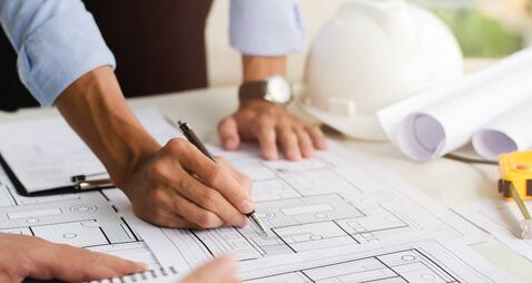 Close-up of an engineer planning a hand-drawn design. with architect equipment Architects talking at the table Teamwork and work