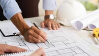 Close-up of an engineer planning a hand-drawn design. with architect equipment Architects talking at the table Teamwork and work