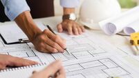 iStock-1358582944.jpg Close-up of an engineer planning a hand-drawn design. with architect equipment Architects talking at the table Teamwork and work