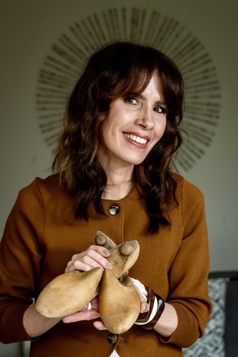 Annmarie O’Connor pictured at home holding a pair of vintage shoe lasts, reflecting her appreciation for craftsmanship and her passion for prolonging the life of clothing and accessories. Picture: Chani Anderson