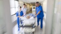 Nurses moving patient on stretcher in hospital