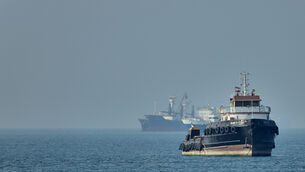 <p>An Iranian tugboat floats in the foreground as cargo ships sit at anchor in the Strait of Hormuz off Bandar Abbas, Iran, Monday, May 4, 2026. (Amirhosein Khorgooi/ISNA via AP)</p>