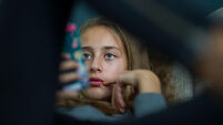 Young girl relax with her smartphone on a sofa