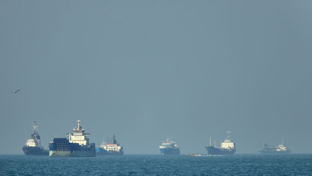 Cargo ships sit at anchor in the Strait of Hormuz (Amirhosein Khorgooi/ISNA/AP)