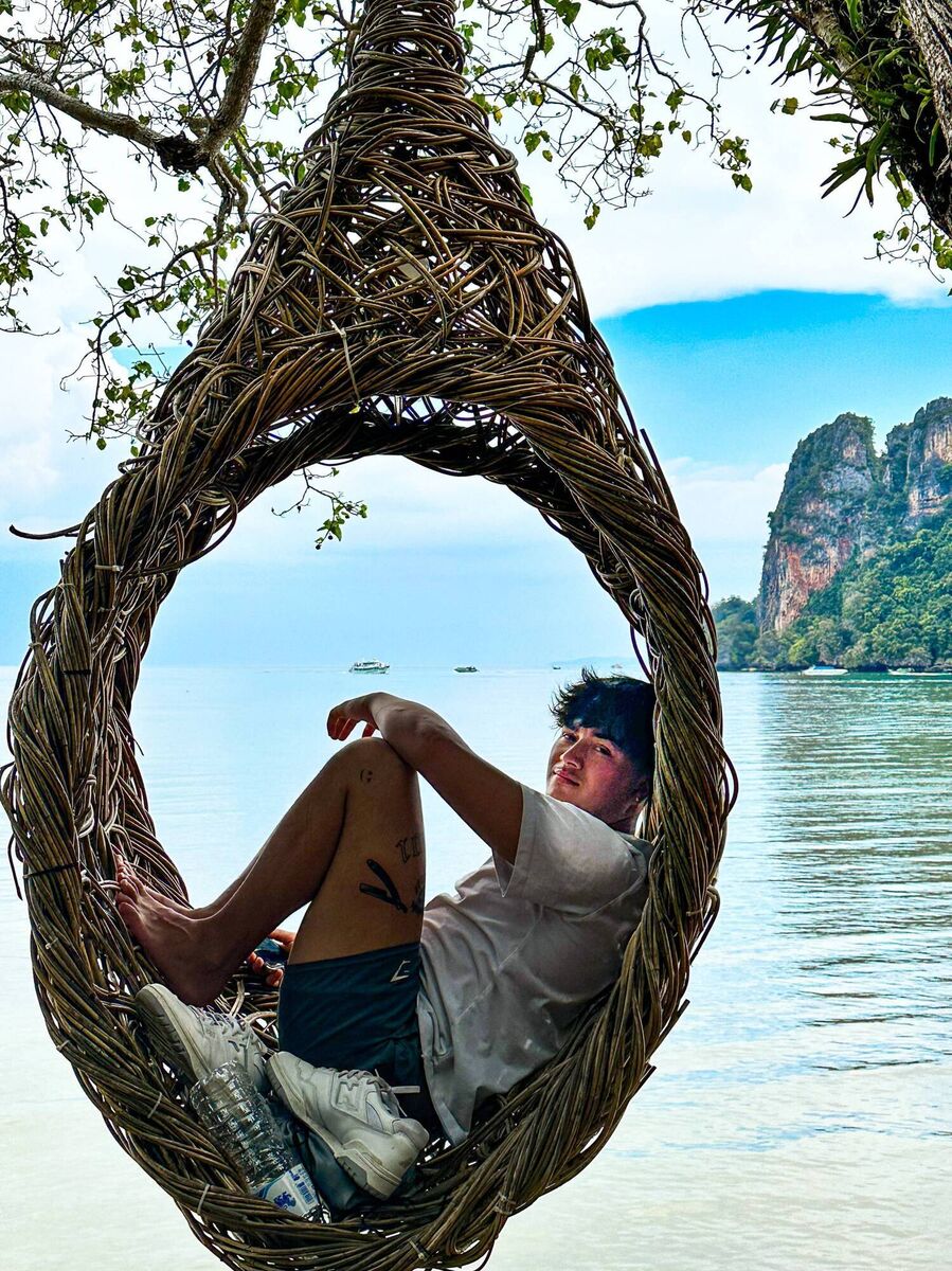 Letting Go in the Land of Smiles: Kai relaxes in a nest swinging over Railay Beach, Krabi.