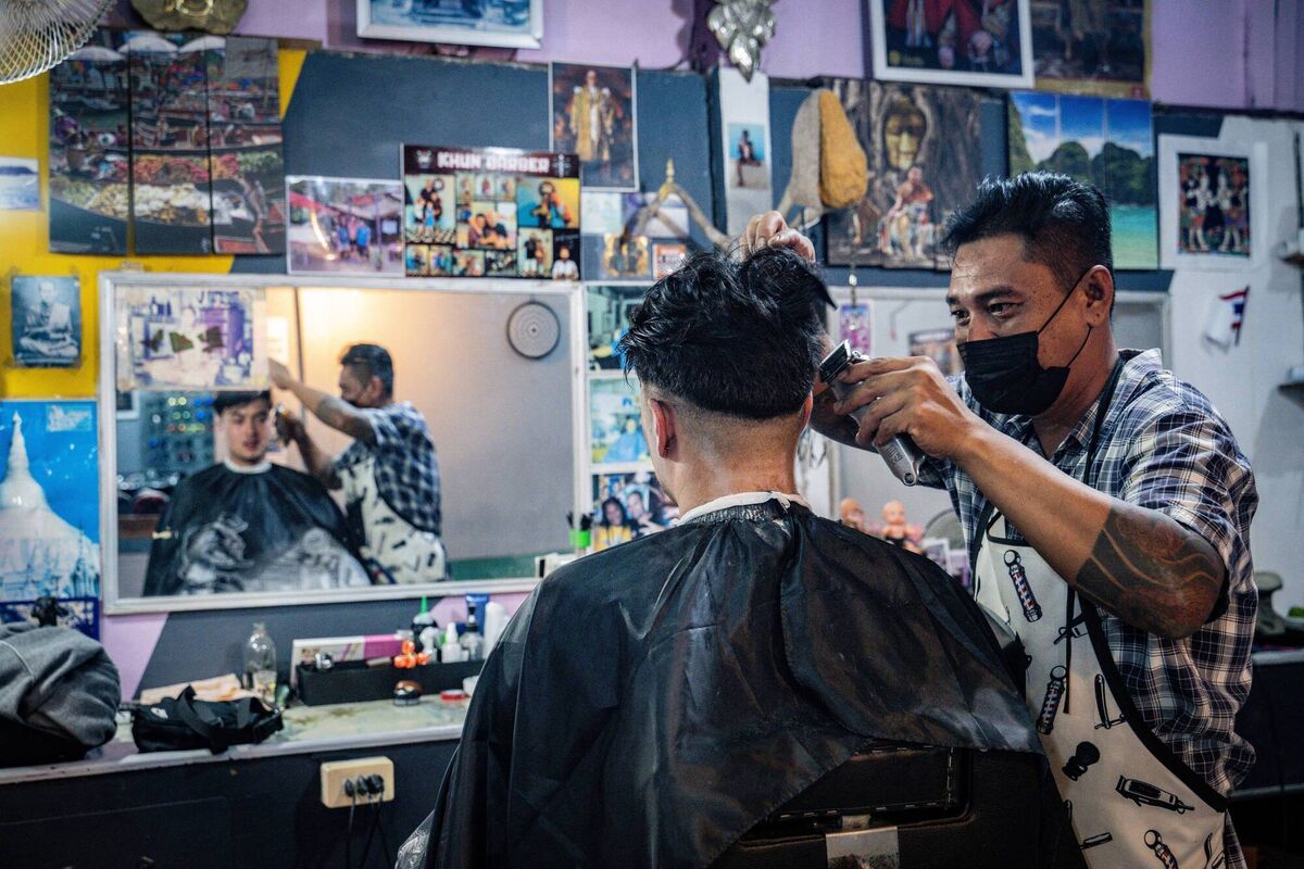 Kai gets a haircut in a night market. Kai gets a haircut in a night market.