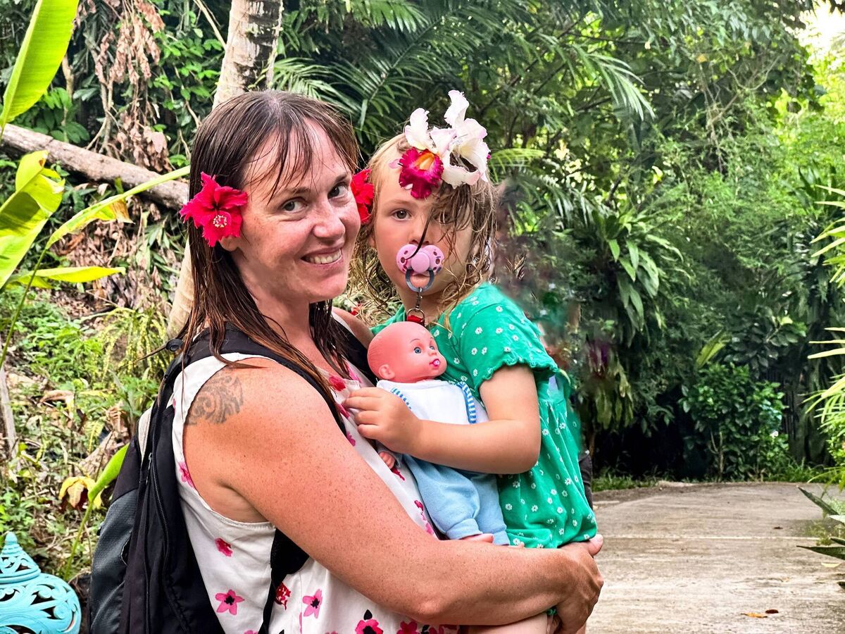 Chani and Evie with flowers in their hair in paradise.