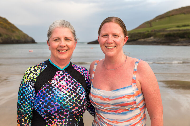 Deirdre McArdle and her sister Ciara Tattan taking a cold plunge in the sea after their sauna at Roberts Cove, Co. Cork.