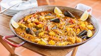 Traditional spanish seafood paella in the fry pan with mussels, langoustine and fish
