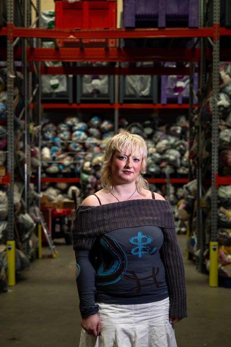 Holly Warren stands before more than 10,000 bags of donated clothing Holly Warren stands before more than 10,000 bags of donated clothing
