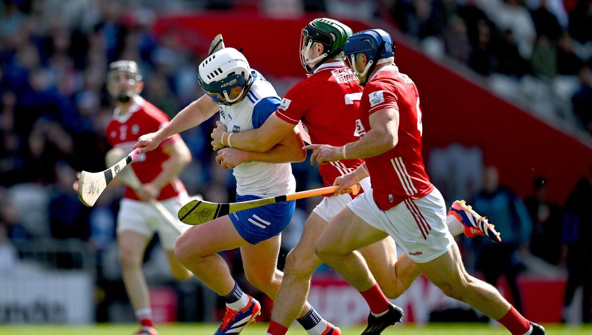 Stephen Bennett of Waterford is tackled by Cork players Mark Coleman, left, and Seán O’Donoghue. Pic: Brendan Moran/Sportsfile