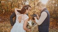 photographer shows just taken photos to wedding couple.