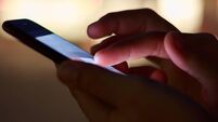 close-up hand using phone in night time on street