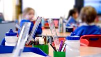 School classroom scene with kids learning in background