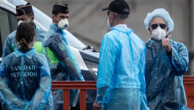 <p>A passenger gives a thumbs-up as Spanish health officials help them disembark the hantavirus-stricken MV Hondius at Granadilla in Tenerife, Canary Islands, Spain, on Sunday. Picture: Chris McGrath/Getty</p>