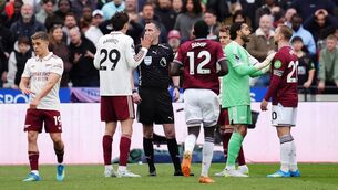 <p>Referee Christopher Kavanagh (centre) is surrounded by Arsenal and West Ham Untied players while awaiting a VAR decision before he is sent to the monitor to disallow West Ham United's Callum Wilson goal during the Premier League match at London Stadium, London. Pic: John Walton/PA Wire</p>