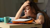 Tired student trying to study in the night