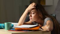 Tired student trying to study in the night