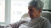 BY285B Old woman sitting in chair