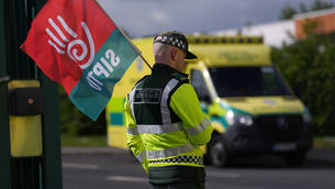 <p>Members of Siptu and Unite unions on the picket line outside National Ambulance Service depot in Dublin South Central (Niall Carson/PA)</p>