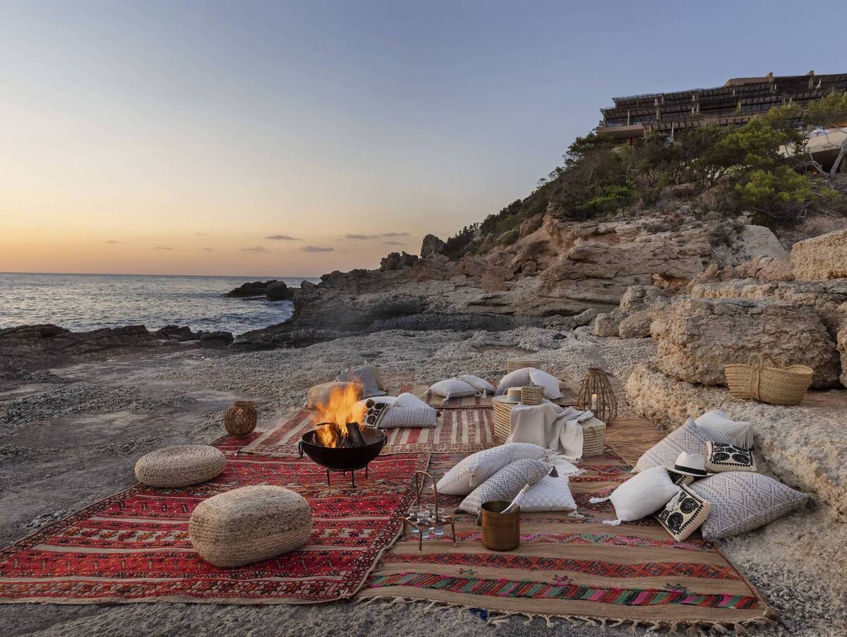 A secluded cove in Ibiza, where beach picnics, clear water and slower afternoons capture a quieter side of the Balearics.