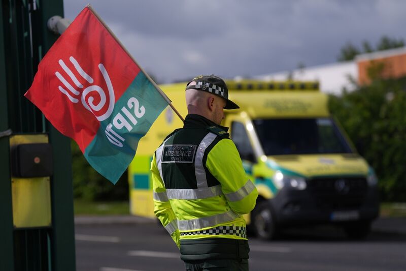 A picketer outside National Ambulance Service depot at Davitt Road in Dublin. Picture: Niall Carson/PA