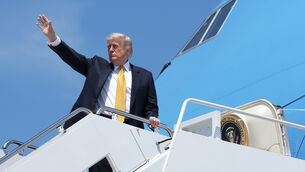 <p>President Donald Trump boards Air Force One on Tuesday (Mark Schiefelbein/AP)</p>