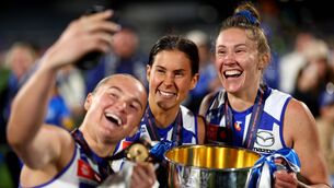 <p>Vikki Wall, Libby Birch and Tahlia Randall of the Kangaroos take a selfie with the Premiership Cup. Pic: Josh Chadwick/AFL Photos/via Getty Images</p>