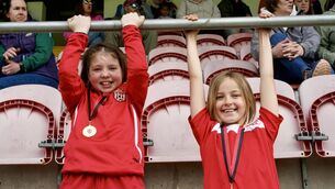 <p>First cousins Sadie Donegan and Penny Fogarty support Killeagh at the Féile Hurling finals in MTU. Picture by Noel Sweeney</p>