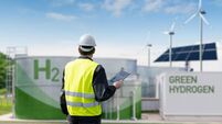 Engineer with tablet computer on a background of Hydrogen factory