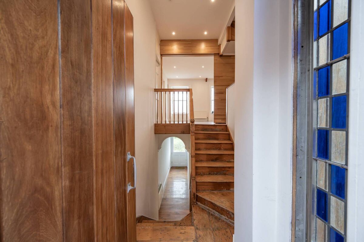 Restored banisters and a glimpse of the feature window with cobalt panes Restored banisters and a glimpse of the feature window with cobalt panes