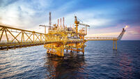 Large offshore drilling rig in the gulf at sunset