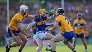 <p>Jake Morris of Tipperary is tackled by Cian Galvin and David McInerney of Clare. Pic: Ray McManus/Sportsfile</p>